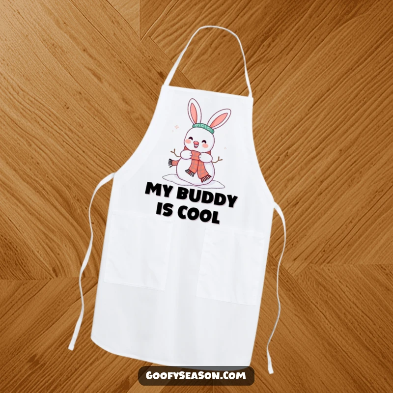 Funny apron displaying a happy bunny character adorning a snowman with a scarf, ready for winter culinary fun.