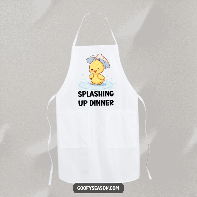 Funny apron showing a happy duckling wearing a tiny umbrella, splashing in a rain puddle.