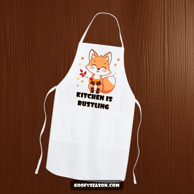 Funny apron showing a cheerful fox character holding colorful autumn leaves, ready for fall-themed cooking.
