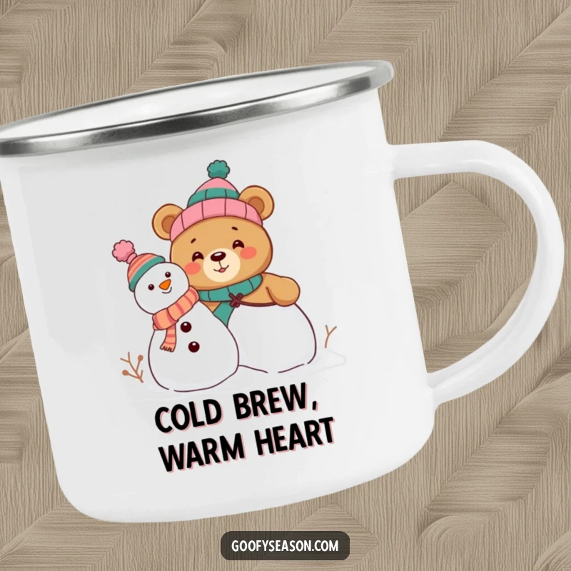 Funny camping mug showing a curious bear character building a snowman, wearing funny mismatched hats, perfect for outdoor humor.