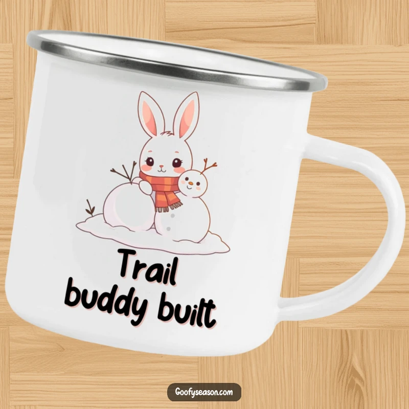 Funny enamel camping mug with a curious bunny wearing a scarf building a snowman, perfect for outdoor enthusiasts and cozy moments.