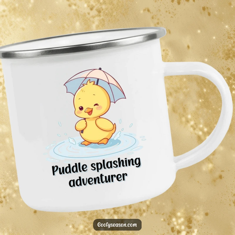 Funny enamel camping mug with a happy duckling wearing a tiny umbrella, splashing in a rain puddle in a rustic setting.