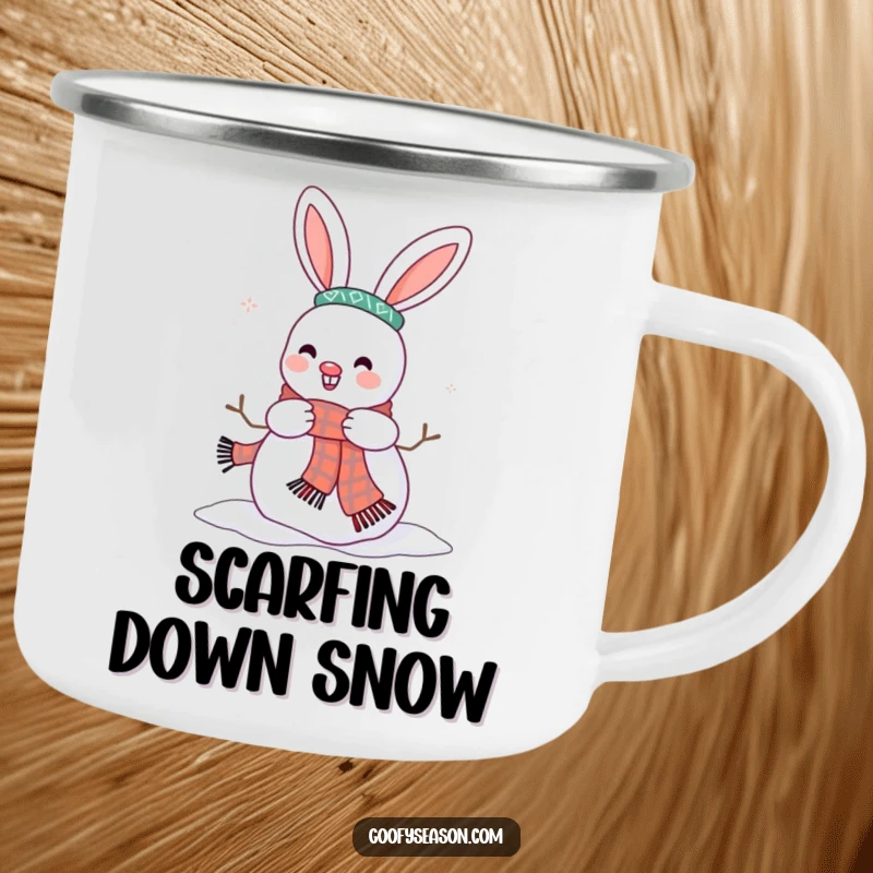 Funny camping mug featuring a happy bunny character adding a scarf to a snowman, perfect for winter adventures.