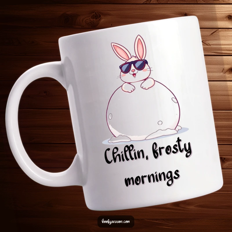 Funny Bunny Mug: A cheerful bunny wearing sunglasses, lounging coolly on a giant snowball, embodying winter relaxation.