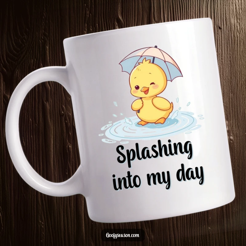 Funny mug showing a happy duckling wearing a tiny umbrella, joyfully splashing in a rain puddle.