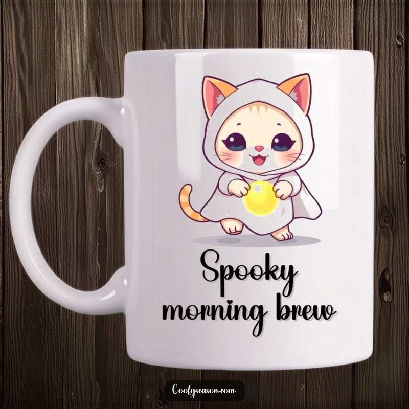 Funny cat in a ghost costume chasing a glowing orb on a Halloween-themed coffee mug.
