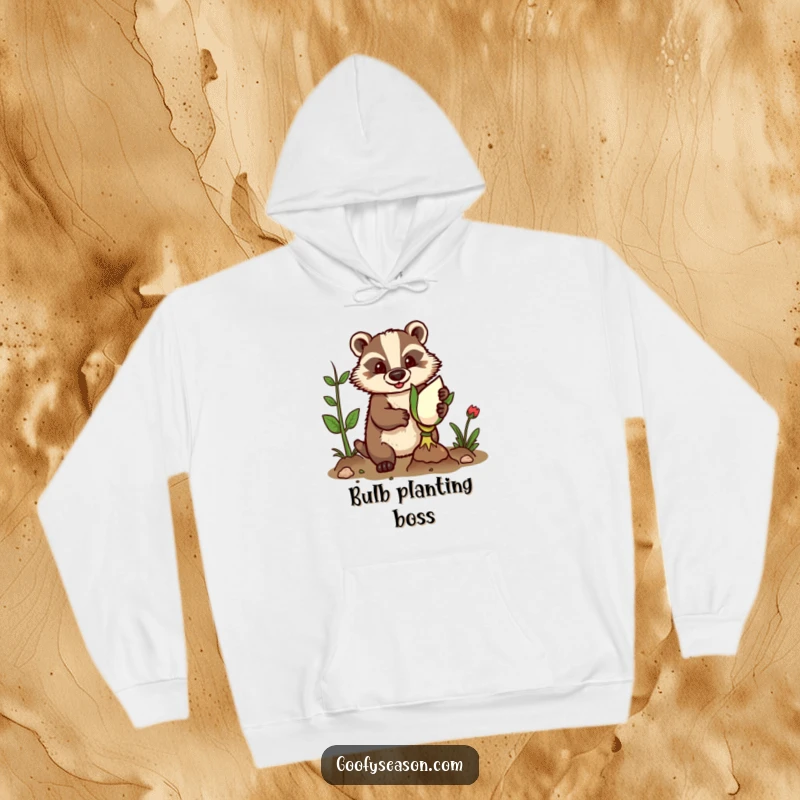 Funny hoodie depicting a determined badger wearing gardening gloves, planting a giant bulb with a serious, focused look.