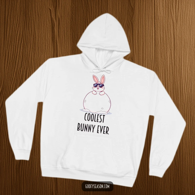 Funny Bunny Hoodie: A cheerful bunny wearing sunglasses, lounging on a giant snowball, perfect for cozy winter days.