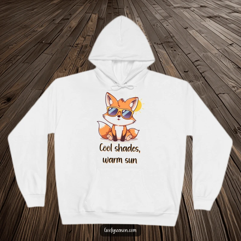 Funny fox with oversized sunglasses enjoying a sunny beach day, featured on a cozy hoodie for cool comfort.