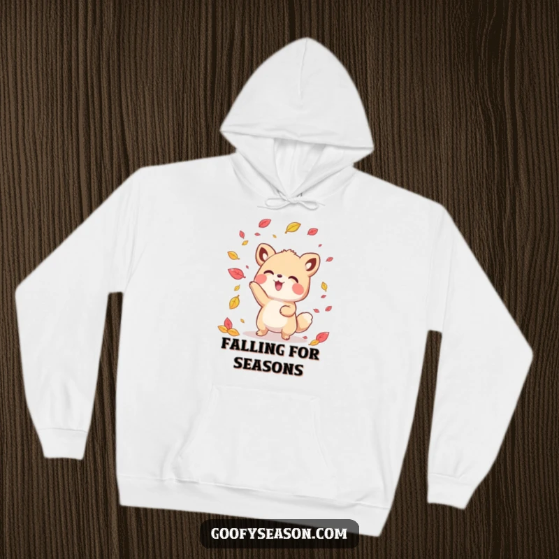 Funny kawaii animal character happily tossing colorful autumn leaves, featured on a warm and cozy hoodie.
