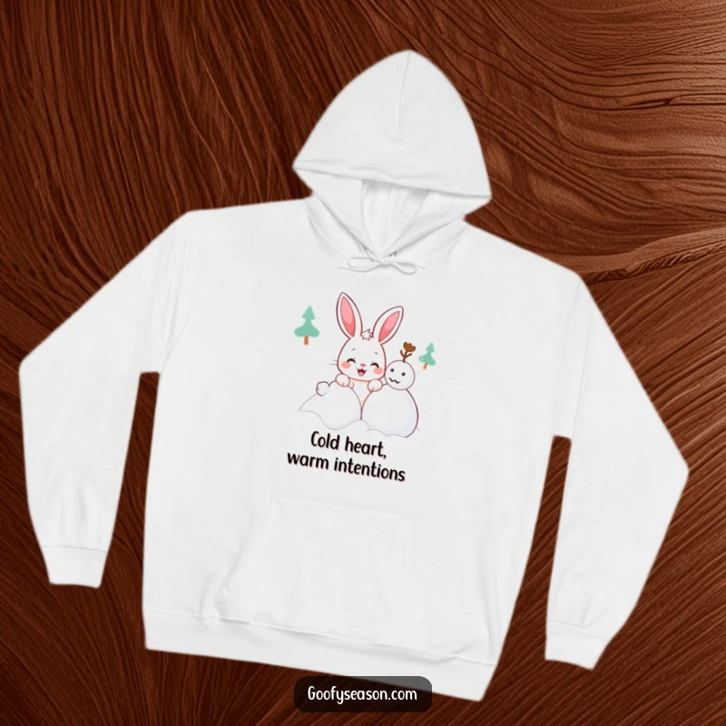 Funny Kawaii bunny hoodie showing a cute character with a mischievous grin attempting to build a snowman, cozy winter wear.