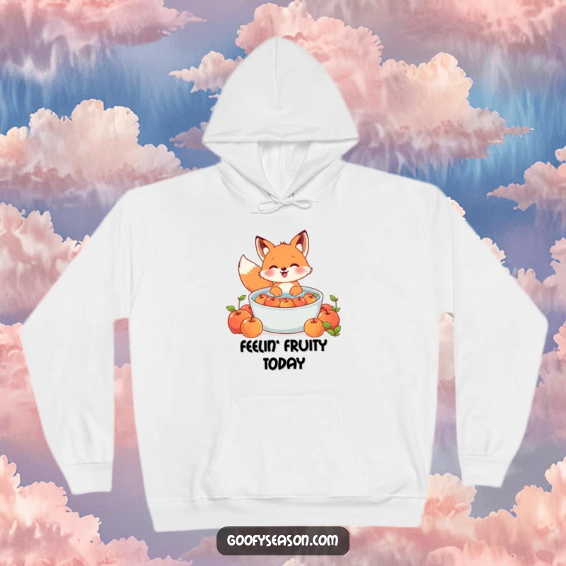 Funny Kawaii fox hoodie showing a cute character gleefully bobbing for apples in a large tub, ideal for cozy days.