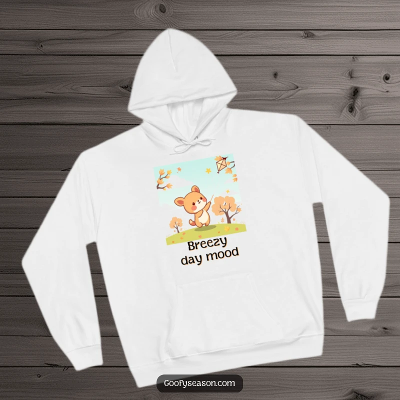 Funny kawaii animal character flying a kite on an autumn day, looking cozy and happy in this hoodie.