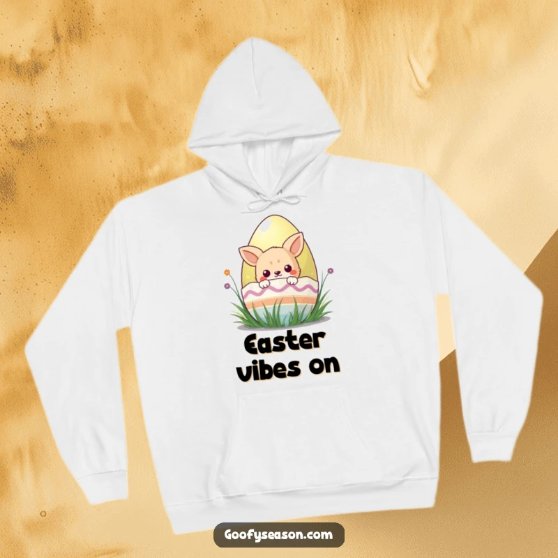 Funny kawaii animal character peeking from behind a colorful Easter egg, looking snug and festive in this hoodie.