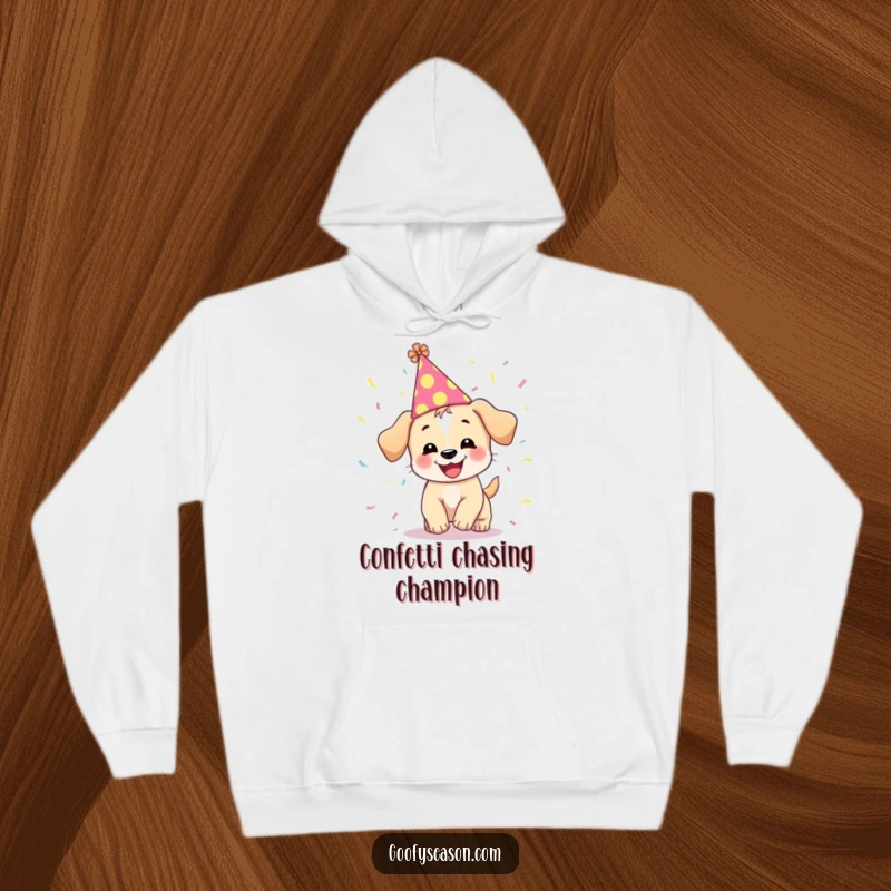 Funny hoodie depicting a giggling puppy in a party hat, enthusiastically chasing swirling confetti.