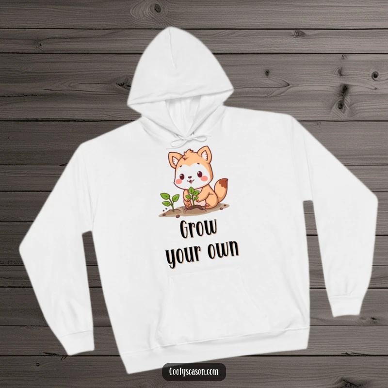 Funny hoodie featuring a determined animal character planting a vibrant seedling with a hopeful and optimistic expression.
