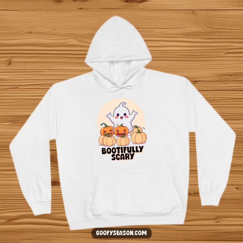 Funny Hoodie: Happy ghost character playfully surprising pumpkins, perfect for cozy, spooky Halloween vibes.