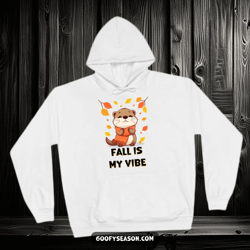 Funny Hoodie: A curious otter in a cozy scarf observes falling leaves with wonder.