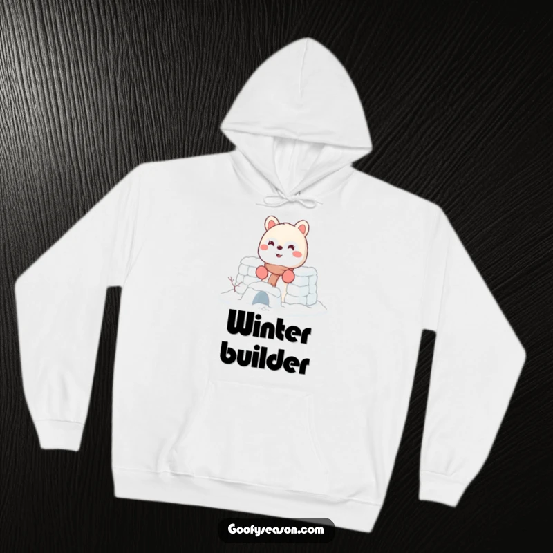 Funny hoodie featuring an energetic animal character with a big smile, wearing tiny mittens and building a sturdy snow fort.