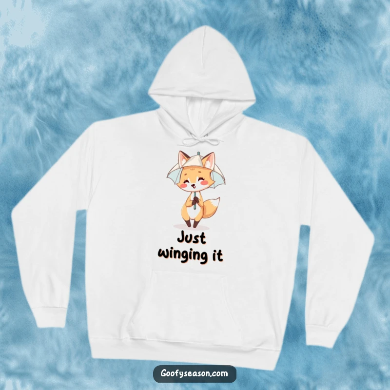 Funny Hoodie: A smiling fox enjoys a gentle rain shower with a tiny umbrella, dancing with glee.