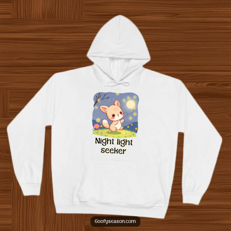 Funny kawaii animal character playfully chasing enchanting fireflies on a dark, warm summer night, featured on a cozy hoodie.