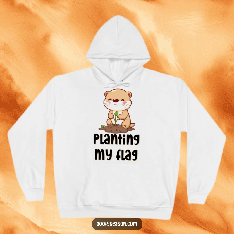 Funny hoodie featuring a determined otter character planting a tiny sprout in spring, illustrating a humorous and heartwarming scene of nature's effort.