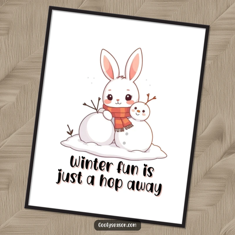 Funny Free Printable Wall Art: A curious bunny wearing a scarf joyfully constructs a snowman, radiating winter cheer.