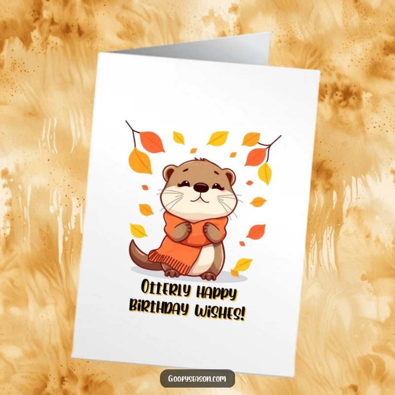 Funny Free Printable Birthday Card: Curious otter in cozy scarf looking at falling leaves, a charming downloadable gift.