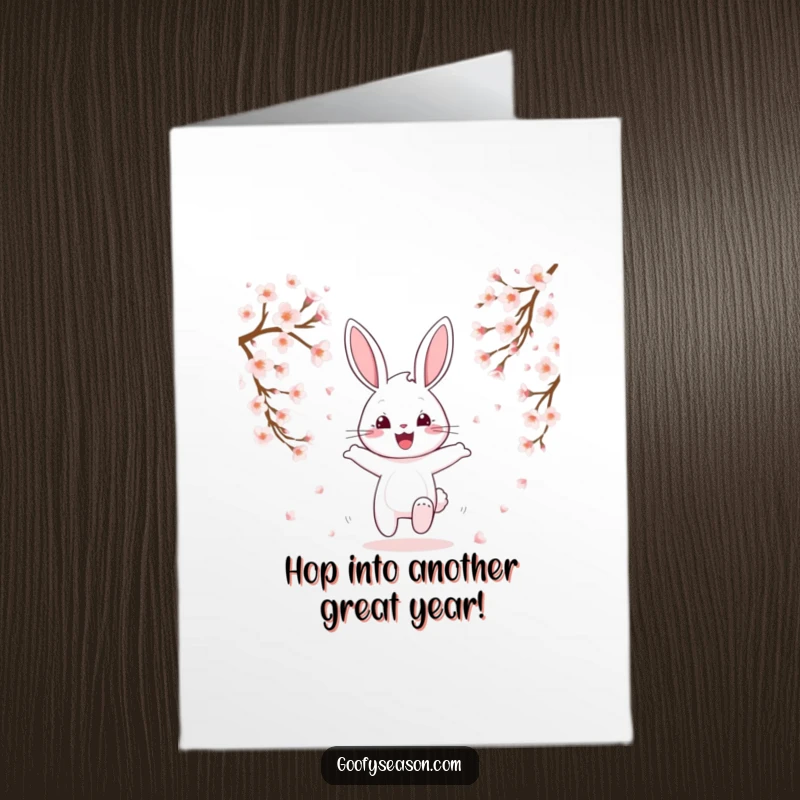 Funny Free Printable Bunny Birthday Card: A happy bunny hops through falling pink cherry blossoms.
