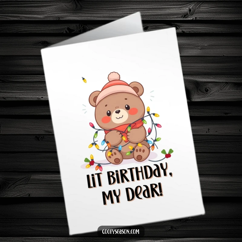 Funny Free Printable Birthday Card: Kawaii bear happily tangled in bright festive winter lights, spreading holiday cheer.