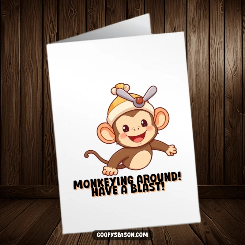 Funny Free Printable Birthday Card: Cheerful monkey pilot in propeller beanie soaring through a blue summer sky.