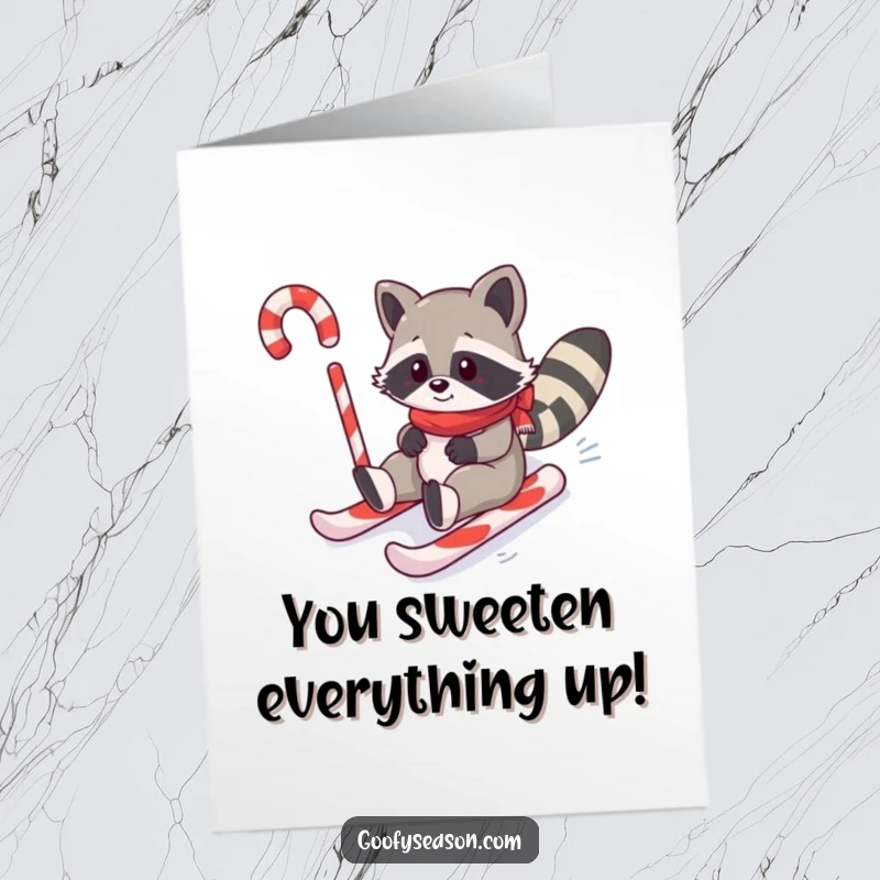 Funny free printable congratulations card featuring a gleeful raccoon sliding down a vibrant candy cane slope.