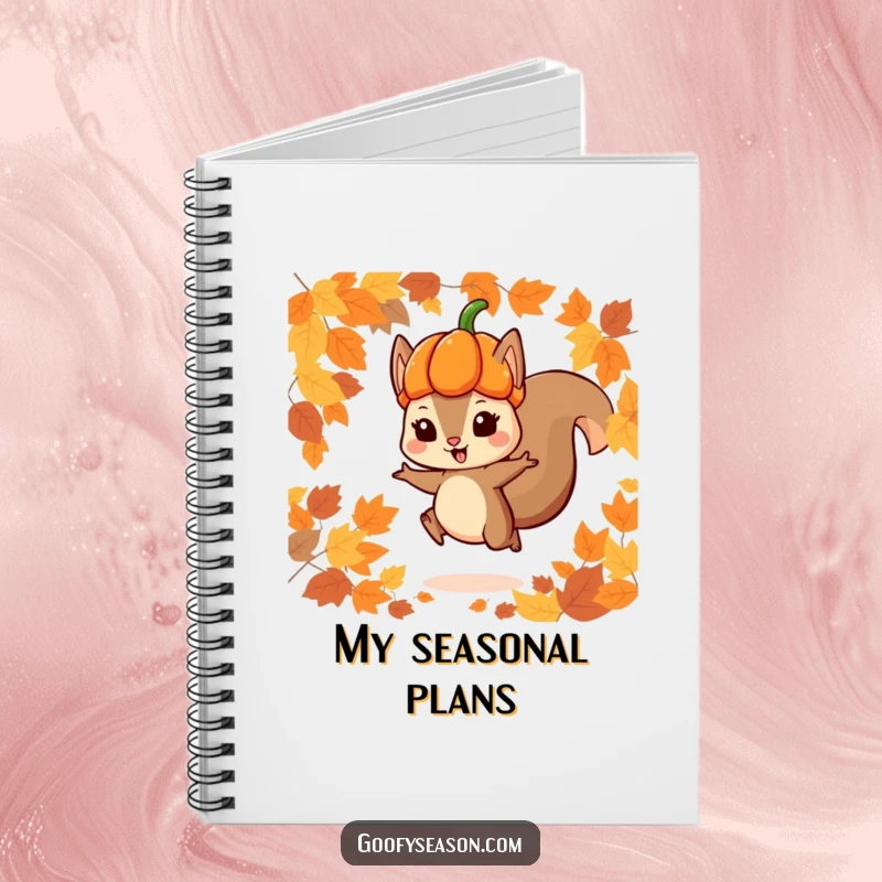 Funny notebook featuring a playful squirrel character in a pumpkin hat jumping through autumn leaves, designed for jotting down notes and ideas.