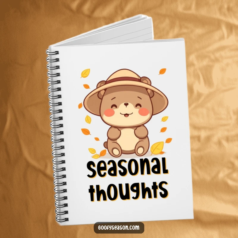 Funny happy bear character wearing a sun hat, catching falling leaves on a notebook cover, inspiring autumn notes and creative ideas.