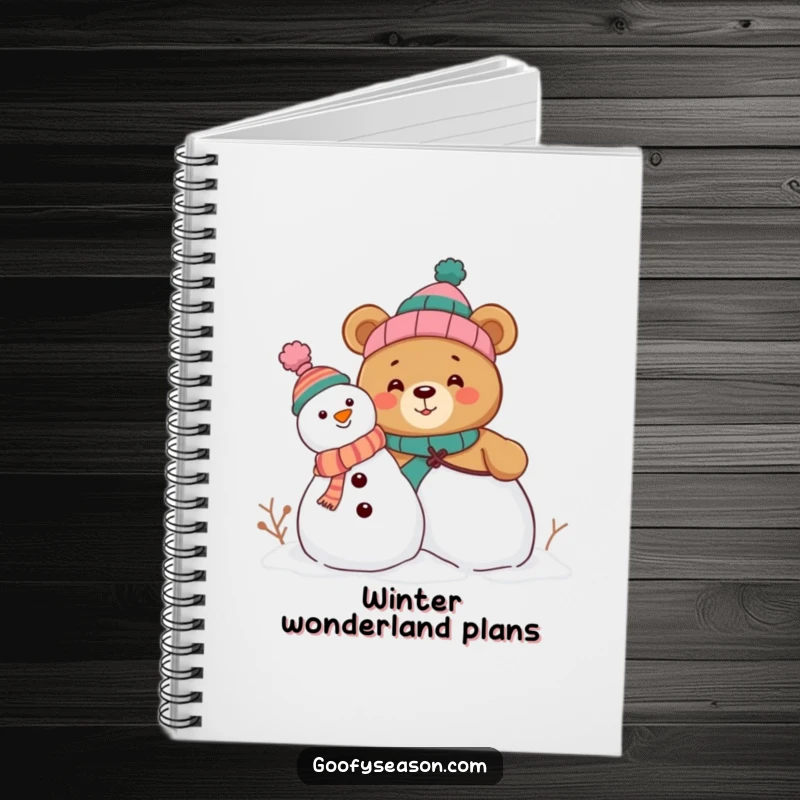 Funny notebook cover showing a curious bear character building a snowman, accessorized with funny, mismatched hats, ready for notes.