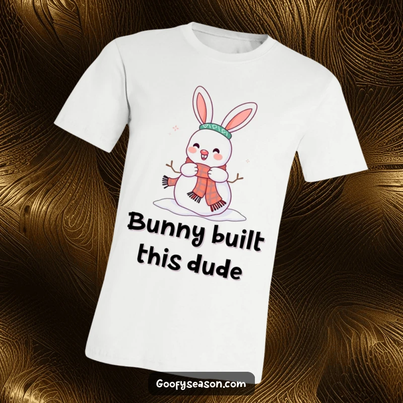 Funny t-shirt depicting a happy bunny character enthusiastically decorating a snowman with a cozy scarf.