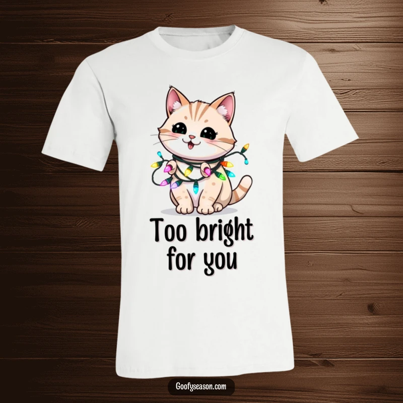 Funny t-shirt showing an energetic cat playfully blinking while tangled in bright holiday Christmas lights.
