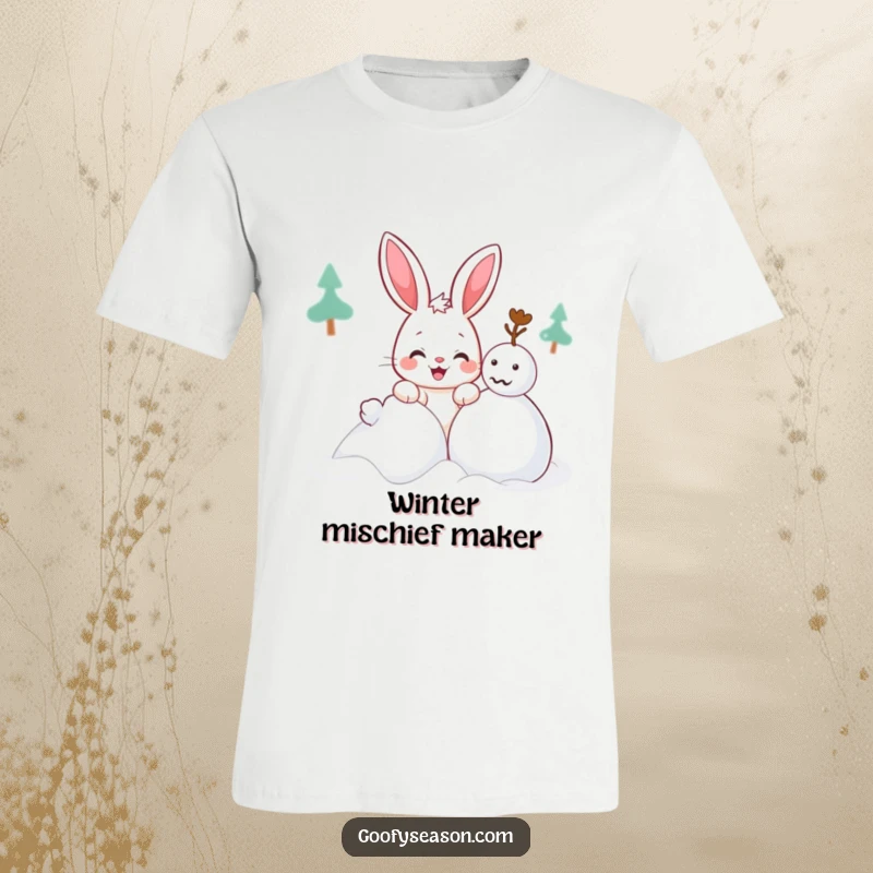 Funny Kawaii bunny t-shirt featuring a cute character with a mischievous grin building a snowman, winter apparel.