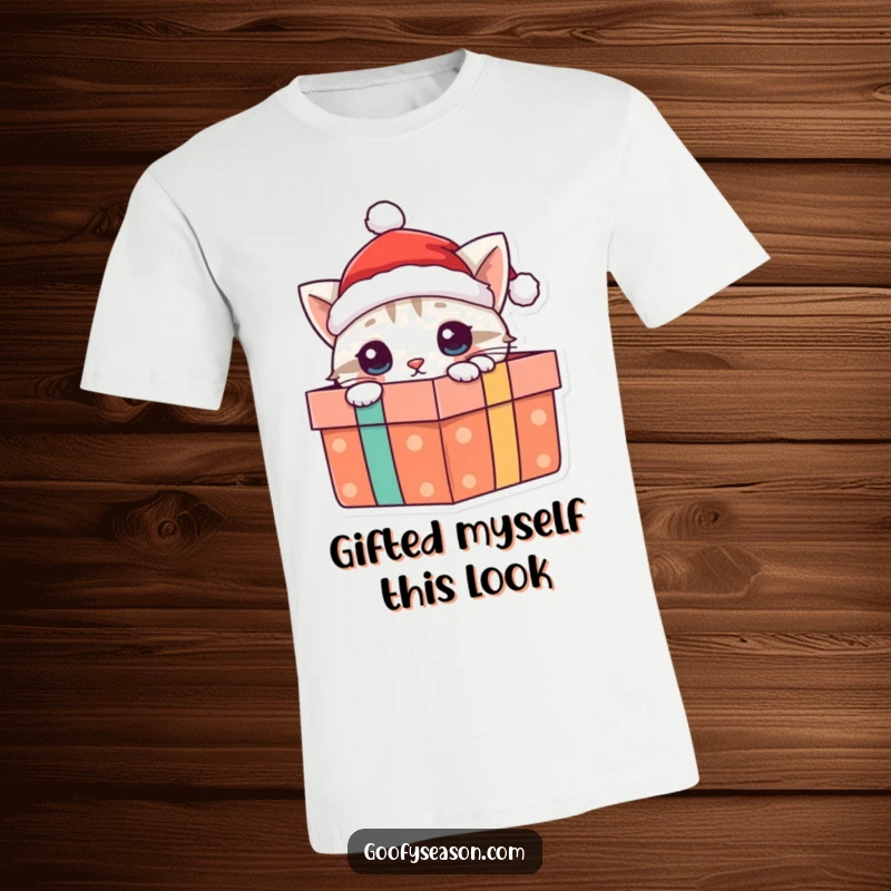 Funny cat t-shirt with a curious cat in a Santa hat emerging from a Christmas present, spreading holiday joy.