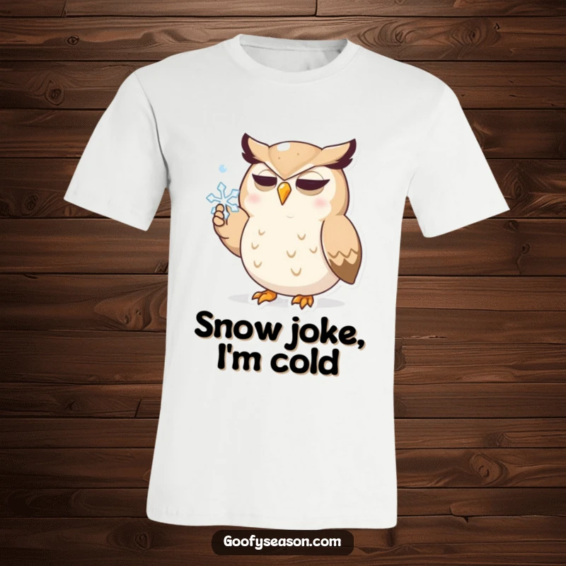 Funny t-shirt with a determined cartoon owl character focused on catching a snowflake with its beak, printed on soft fabric.