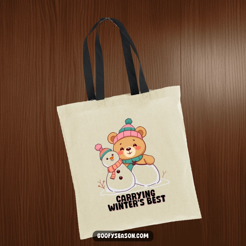 Funny tote bag with a curious bear character stacking a snowman, adorned with a variety of funny, mismatched hats for a humorous touch.