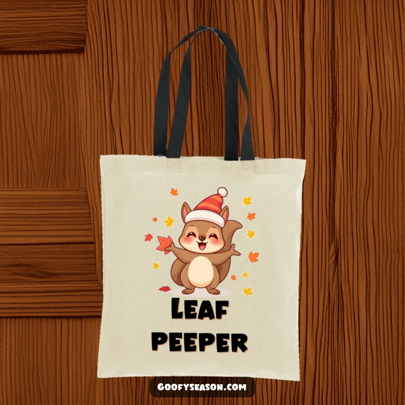 Funny Tote Bag: Joyful squirrel character in a festive hat, juggling colorful autumn leaves.