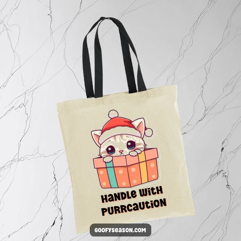 Funny cat tote bag with a curious cat wearing a Santa hat, peeking playfully out of a gift box, great for shopping.