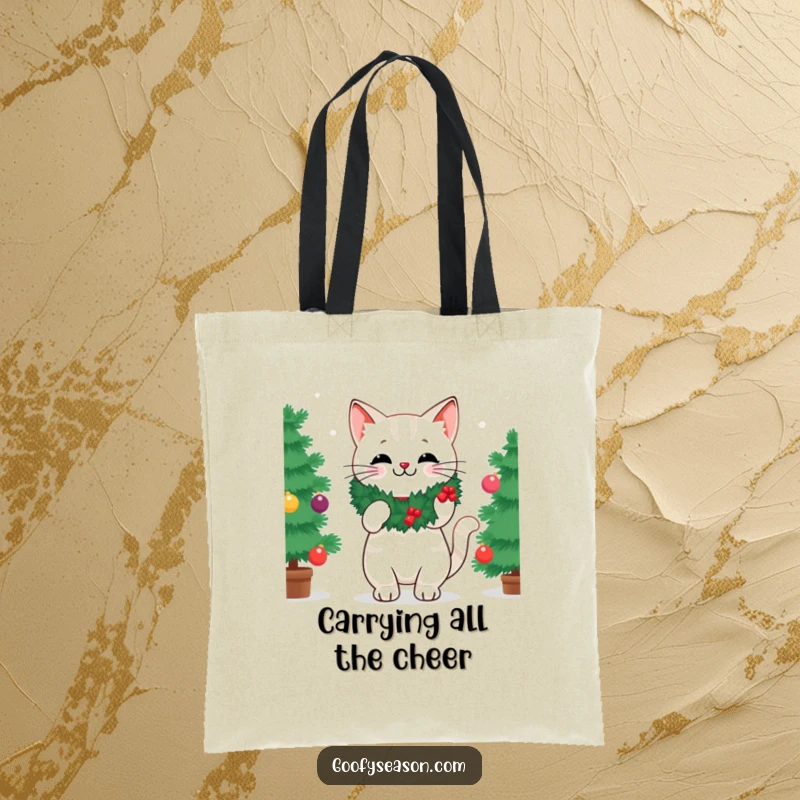 Funny tote bag illustrating a cheerful cat wearing a wreath, busy decorating a vibrant Christmas tree with festive ornaments.